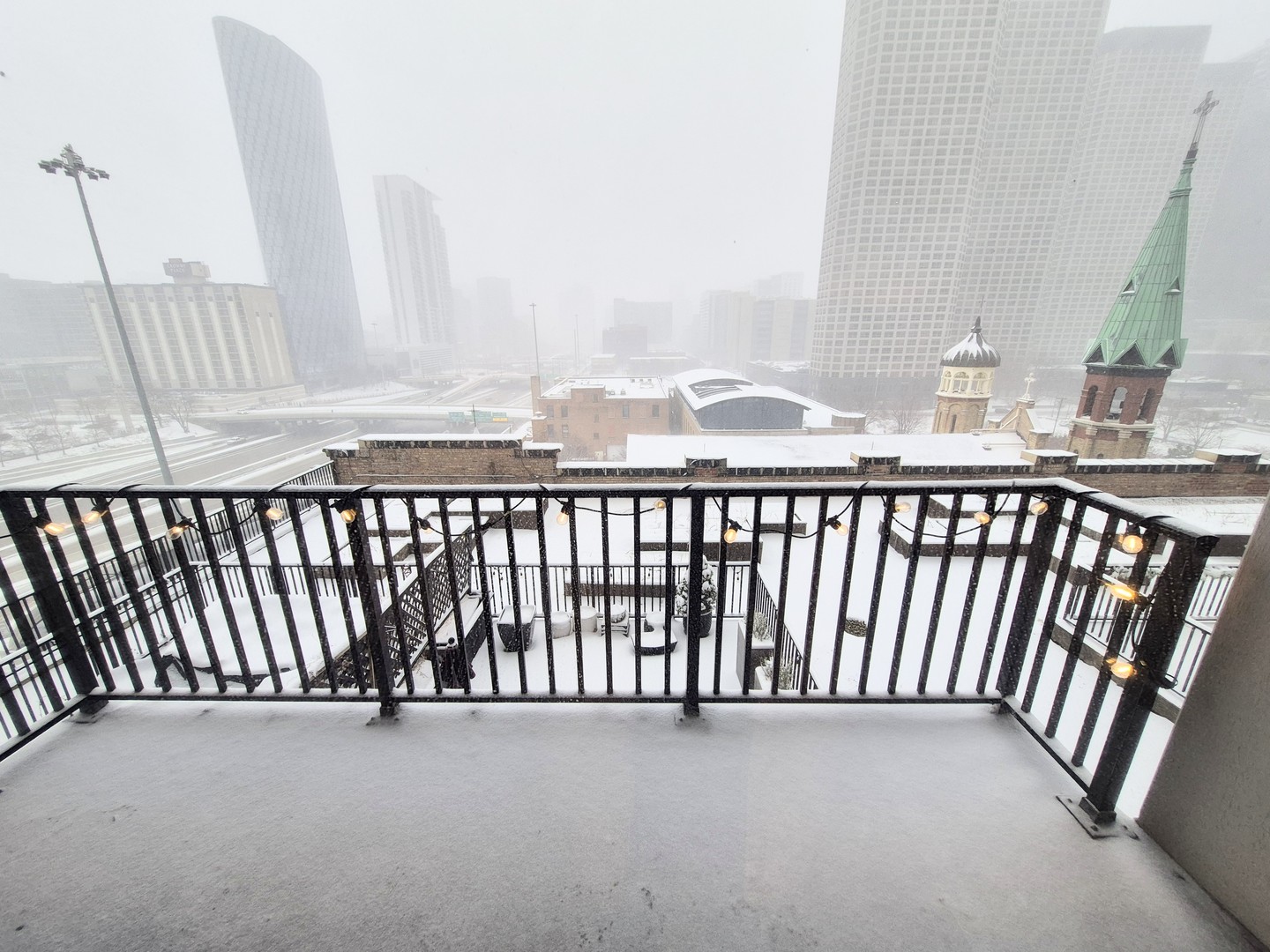 210 South Desplaines Street, Unit 707 Chicago, IL 60661 - Photo 17 of 21 a view of a city skyline from a balcony