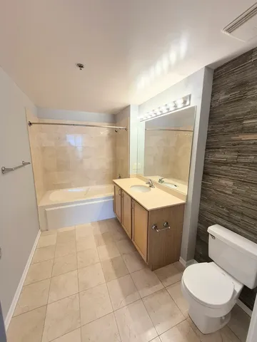 a bathroom with a sink mirror vanity and toilet
