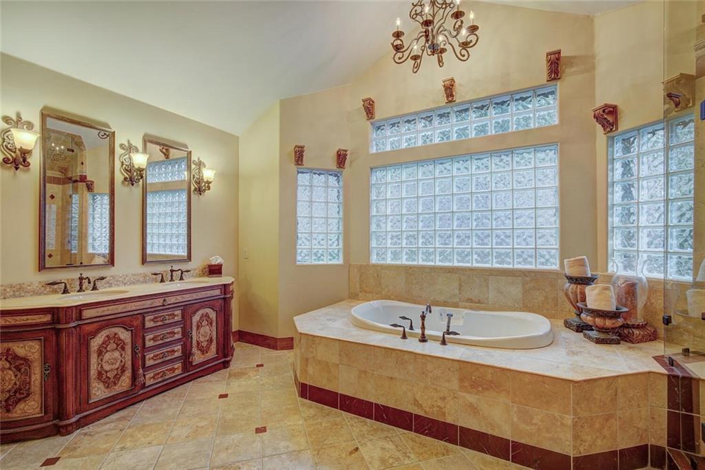 1065 4 O Clock Road Breckenridge, CO 80424 - Photo 16 of 35 a spacious bathroom with a tub sink and mirror