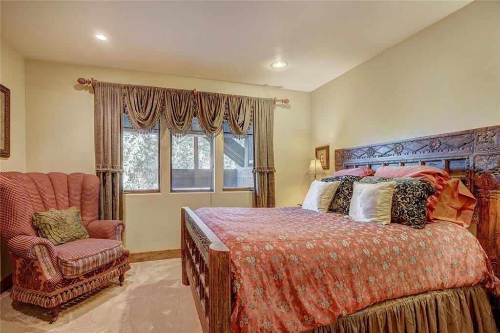 1065 4 O Clock Road Breckenridge, CO 80424 - Photo 17 of 35 a bedroom with a large bed and a couch