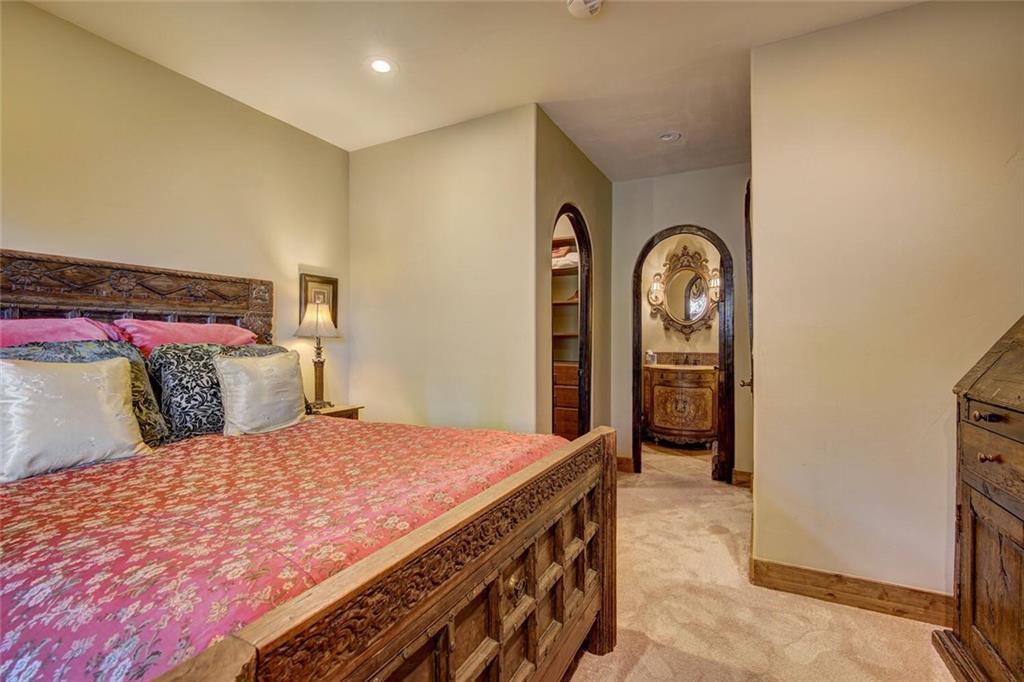 1065 4 O Clock Road Breckenridge, CO 80424 - Photo 18 of 35 a bedroom with a bed and a dresser