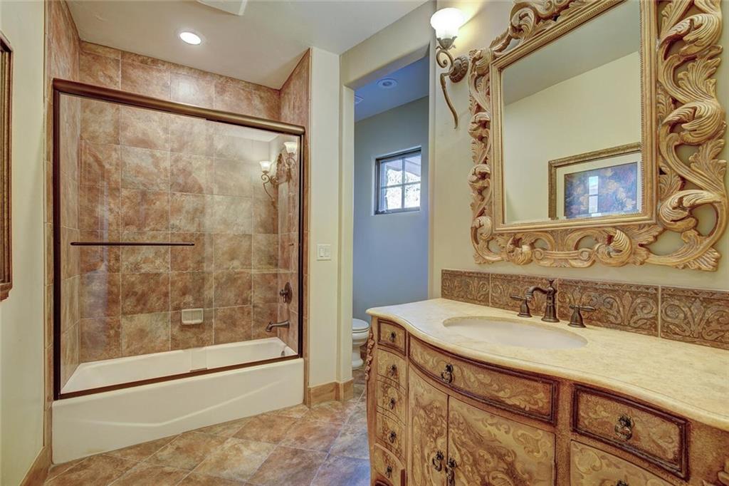 1065 4 O Clock Road Breckenridge, CO 80424 - Photo 19 of 35 a bathroom with a granite countertop sink a mirror and shower