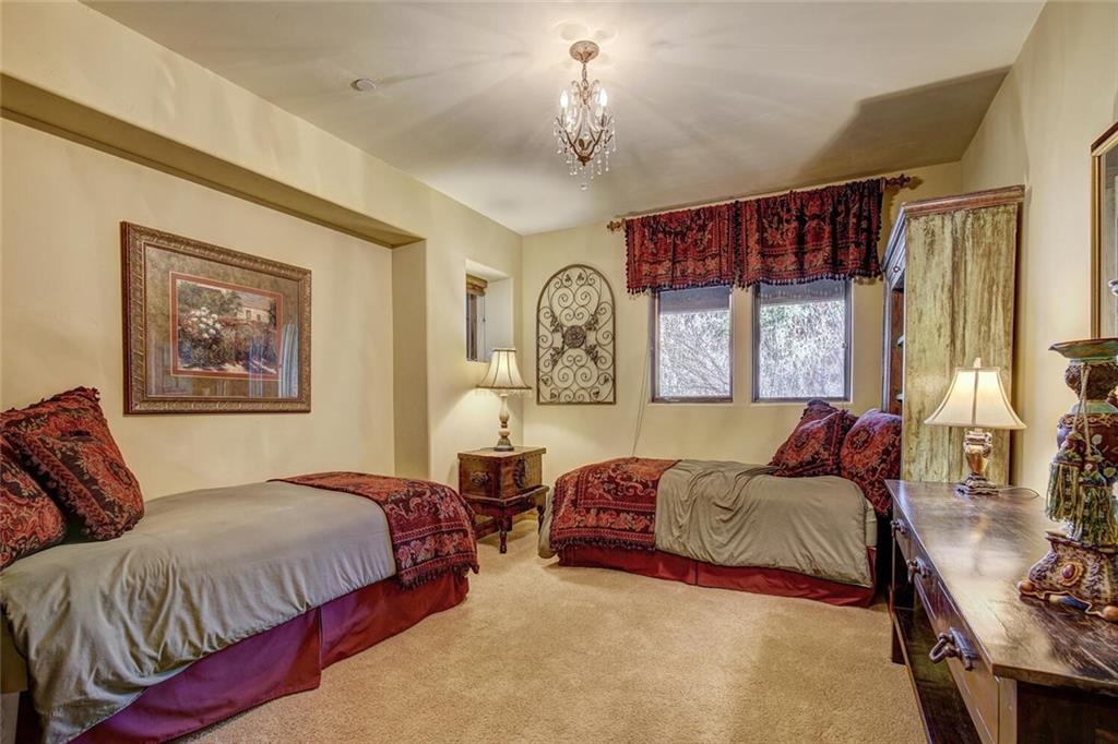 1065 4 O Clock Road Breckenridge, CO 80424 - Photo 23 of 35 a spacious bedroom with a large bed and a window