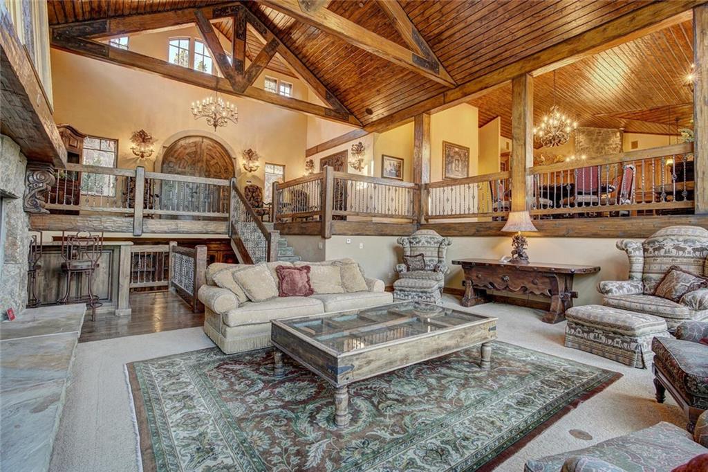 1065 4 O Clock Road Breckenridge, CO 80424 - Photo 29 of 35 a living room with furniture and a chandelier