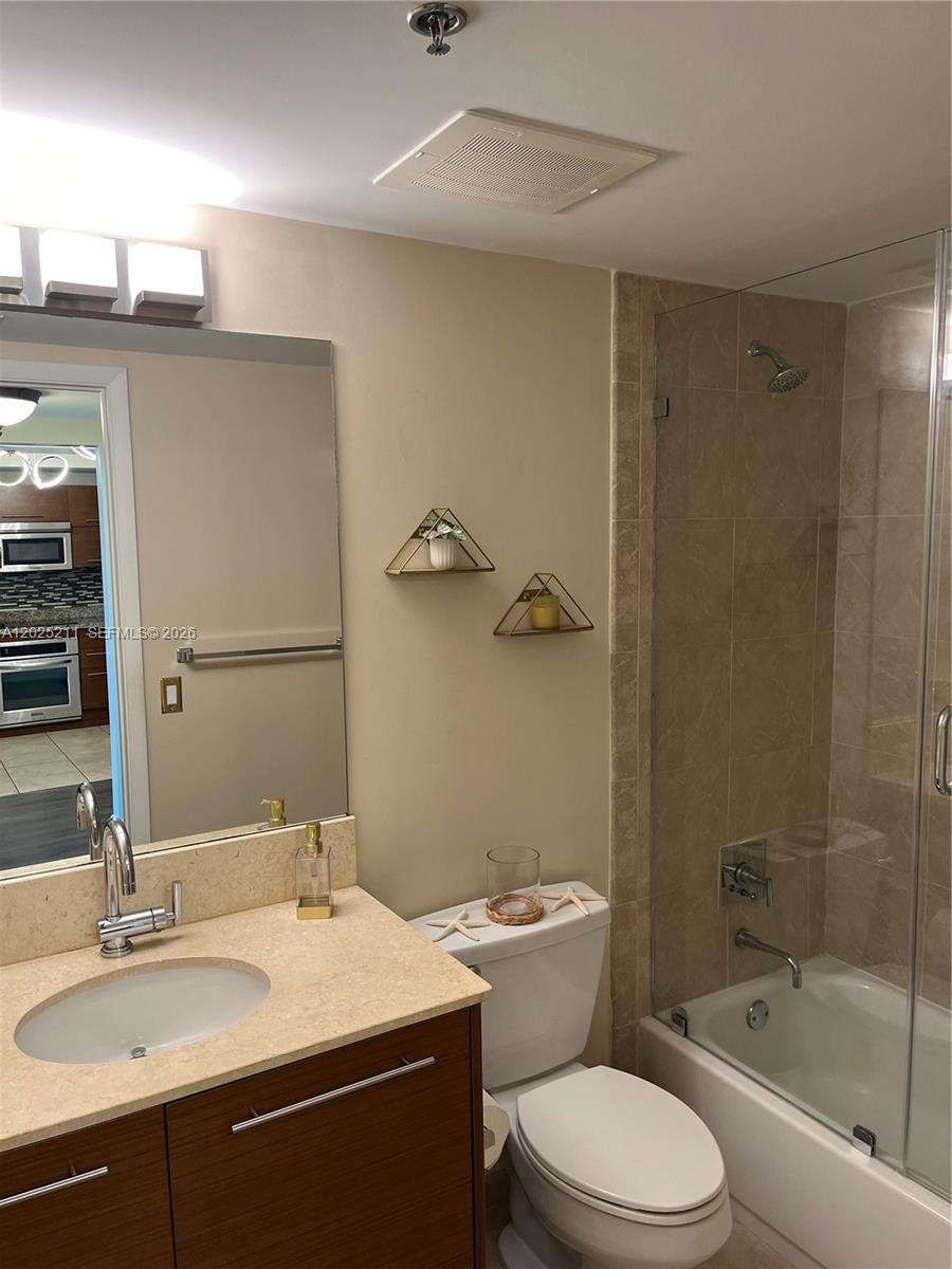 2681 North Flamingo Road, Unit 303S Sunrise, FL 33323 - Photo 13 of 18 a bathroom with a sink a toilet and shower