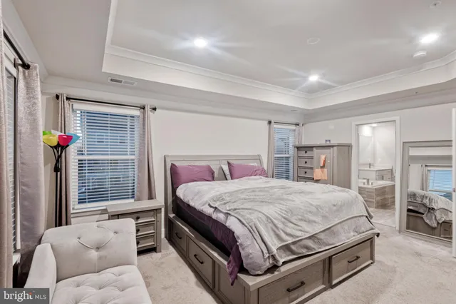 a bedroom with a bed and dresser with mirror