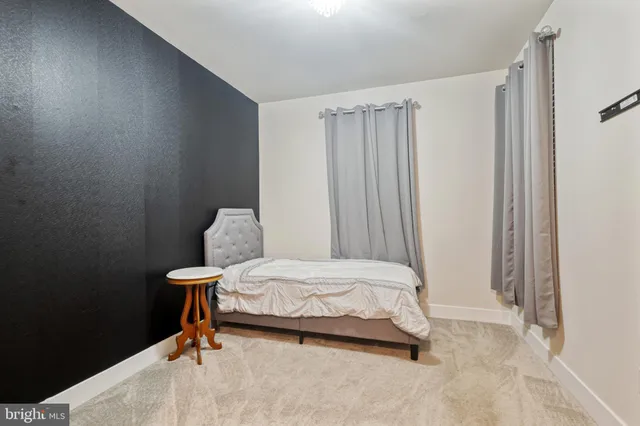 a bedroom with a bed and a table chair