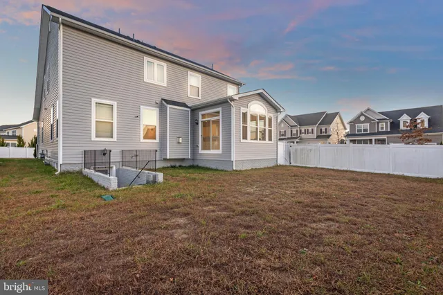 a front view of a house with yard and seating space
