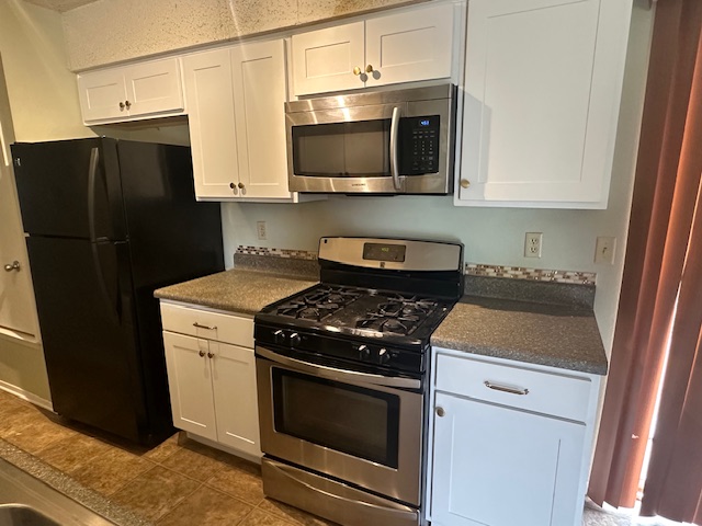 3603 Buffalo Springs Trail, Unit B Georgetown, TX 78628 - Photo 1 of 16 a kitchen with stainless steel appliances a stove microwave and refrigerator