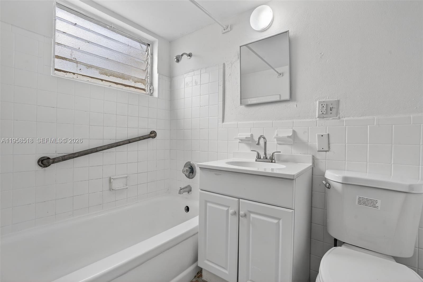 1716 Northwest 19th Street Miami, FL 33125 - Photo 11 of 20 a bathroom with a sink toilet and vanity