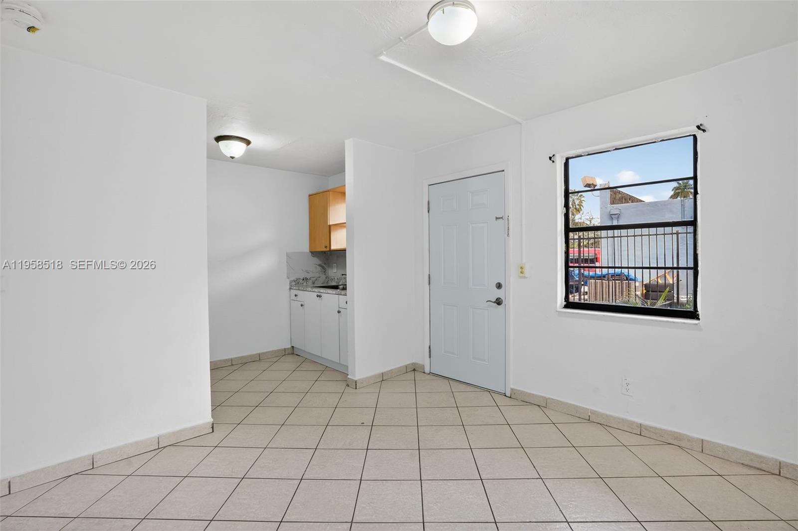 1716 Northwest 19th Street Miami, FL 33125 - Photo 6 of 20 a view of an empty room and window