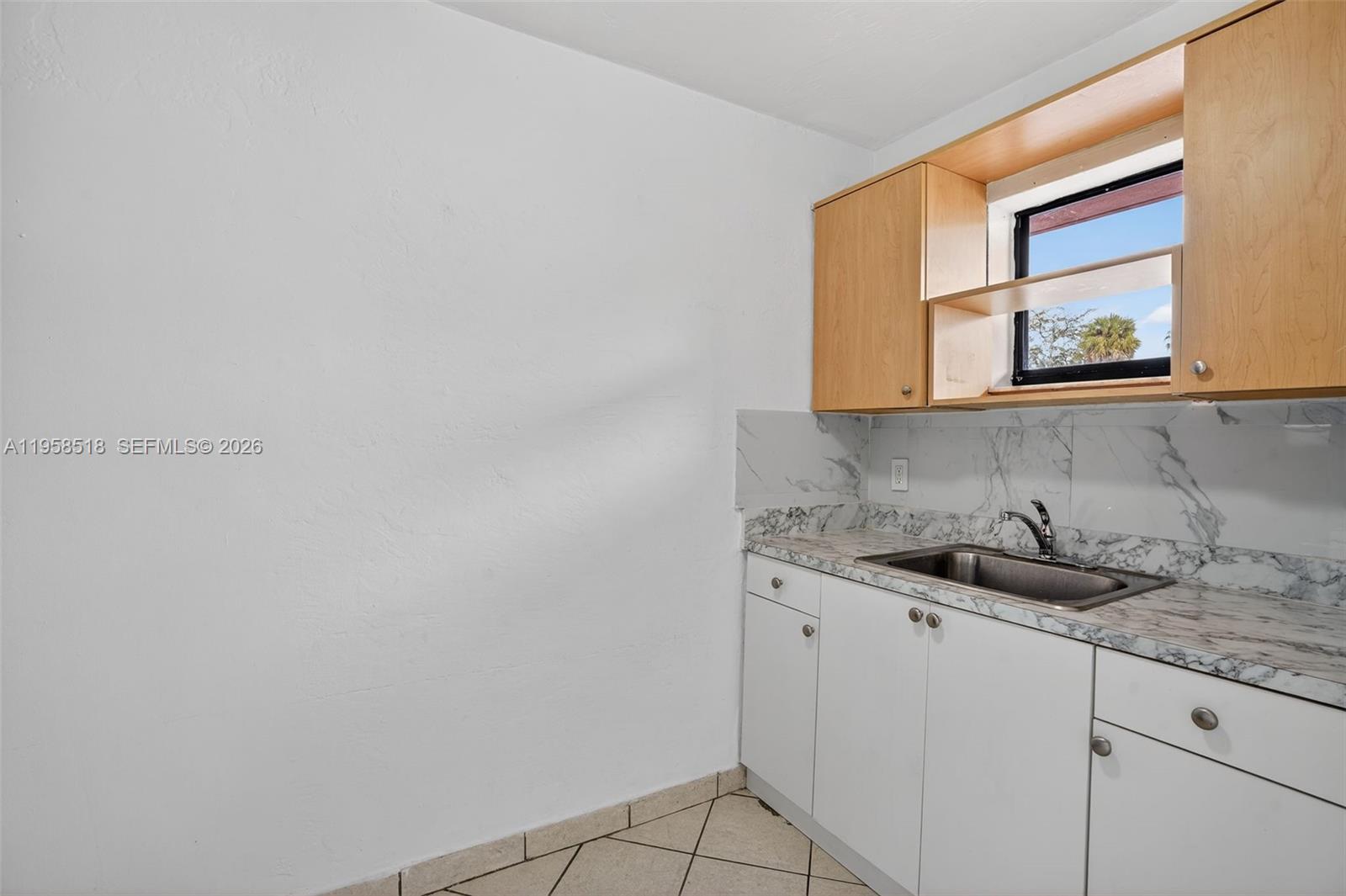 1716 Northwest 19th Street Miami, FL 33125 - Photo 7 of 20 a bathroom with a sink and a mirror