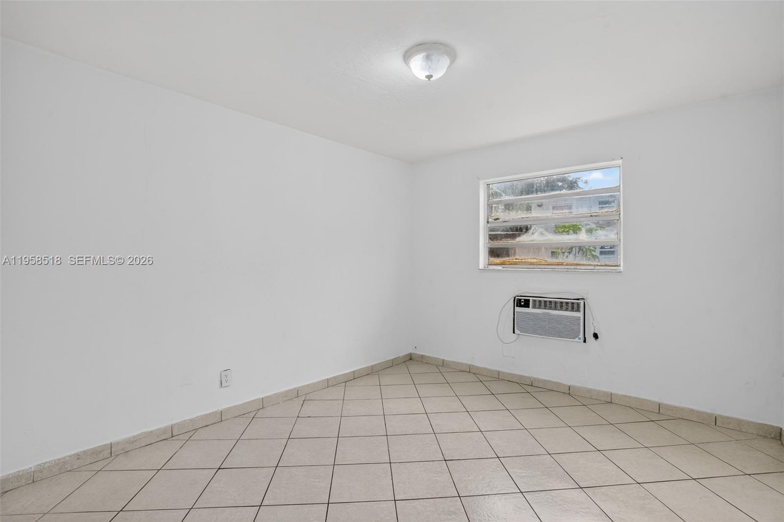 1716 Northwest 19th Street Miami, FL 33125 - Photo 9 of 20 an empty room with windows