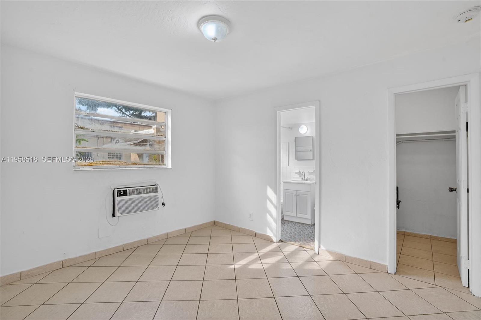 1716 Northwest 19th Street Miami, FL 33125 - Photo 10 of 20 a view of an empty room and window