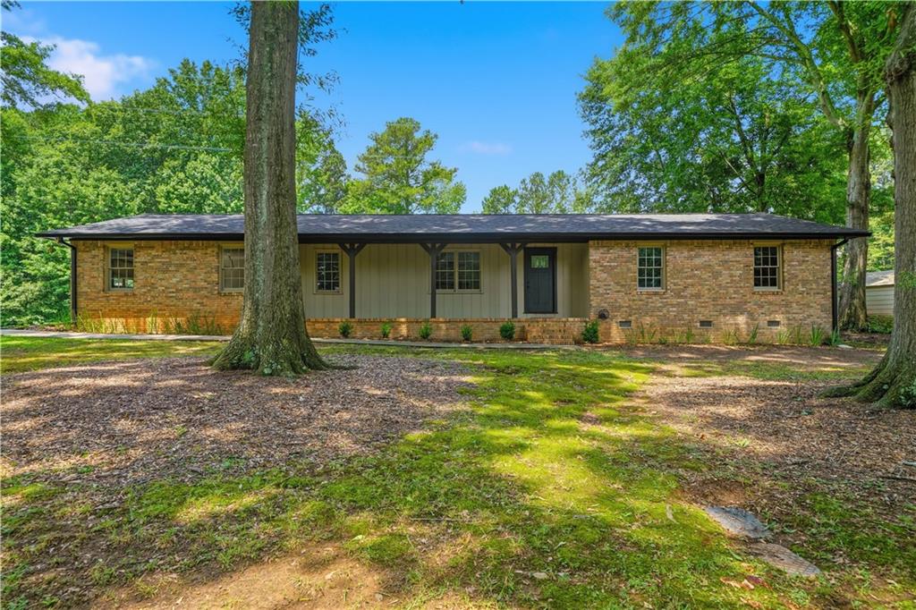 125 Childers Road Canton, GA 30115 - Photo 5 of 48 a front view of house with yard and trees in the background