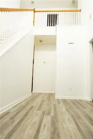 a view of a room with wooden floor