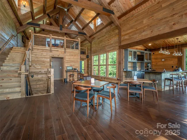 a dining room with wooden floor a table and chairs