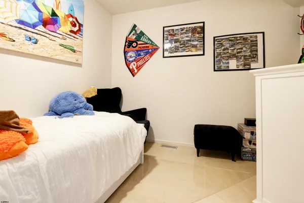 a view of a livingroom with wooden floor and a ceiling fan