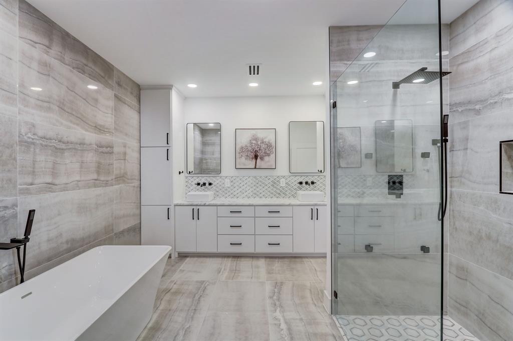 a bathroom with a double vanity sink mirror and shower