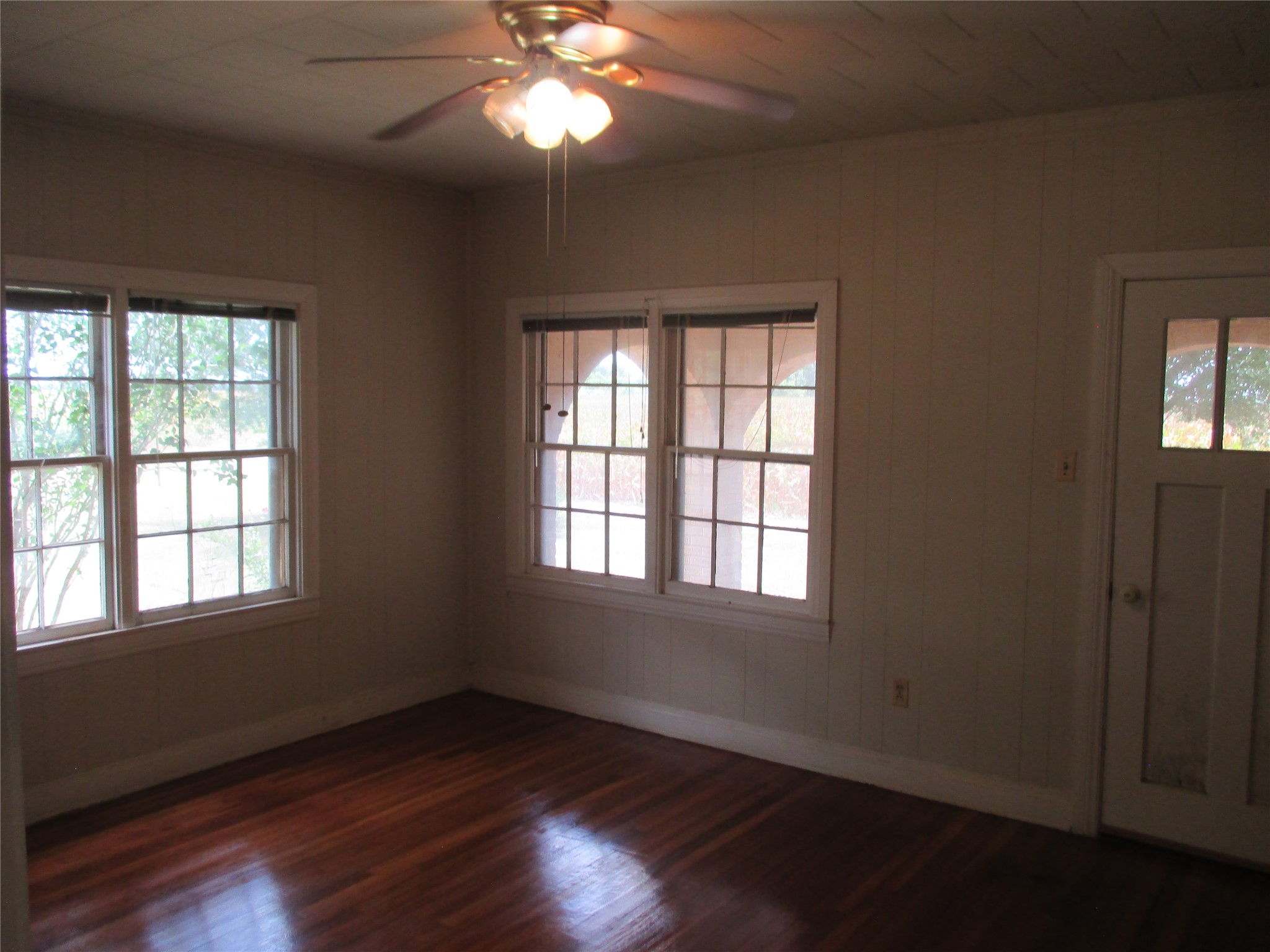12610 Pecan School Road Bartlett, TX 76511 - Photo 12 of 21 Rich hardwood floors complement multiple sun-filled windows and a unique panel-style door.