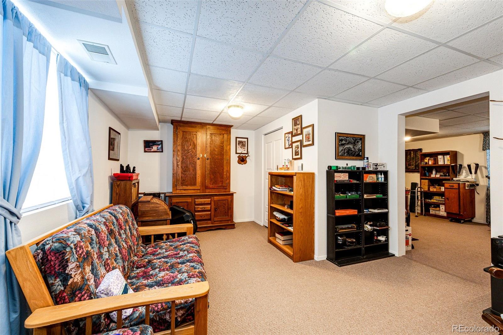 4420 Behrens Road Byers, CO 80103 - Photo 16 of 39 a living room with furniture and a flat screen tv