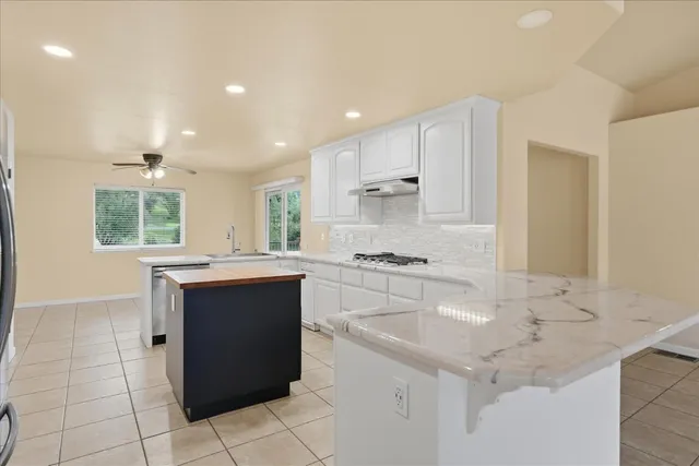 a kitchen with stainless steel appliances granite countertop a sink and cabinets