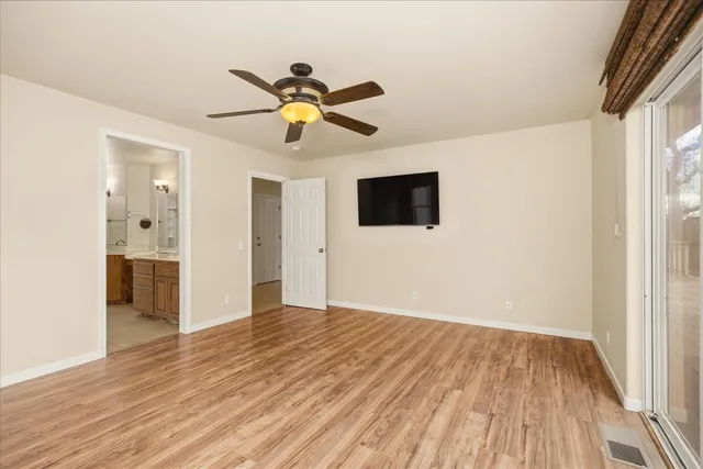 a large kitchen with a large counter top a refrigerator and a sink