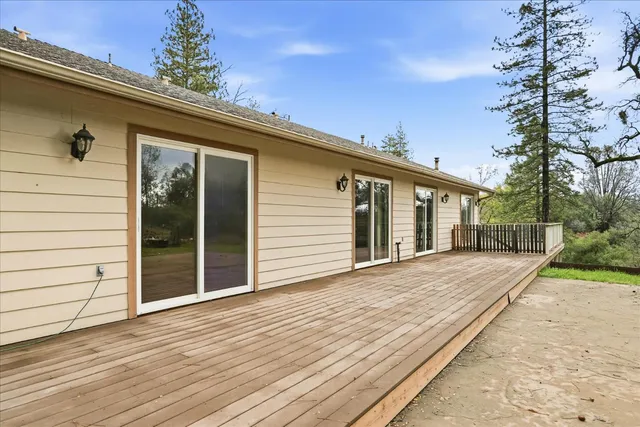 a view of outdoor space with deck and yard
