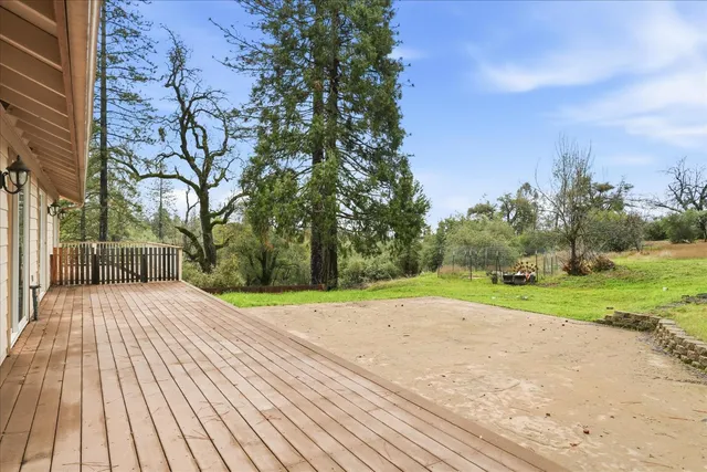 a view of a balcony with wooden floor and fence
