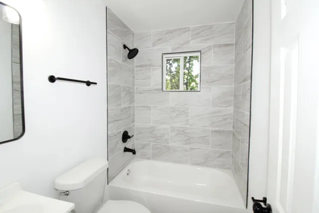 a bathroom with a bathtub and a shower