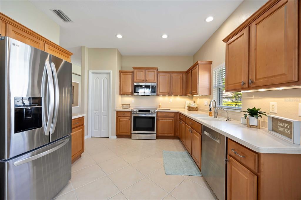 8769 Monterey Bay Loop Bradenton, FL 34212 - Photo 13 of 64 a kitchen with stainless steel appliances granite countertop a refrigerator a sink dishwasher a stove top oven a sink and dishwasher