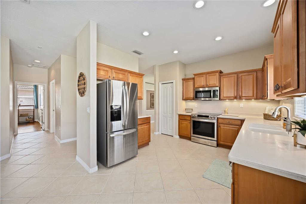 8769 Monterey Bay Loop Bradenton, FL 34212 - Photo 14 of 64 a kitchen with stainless steel appliances granite countertop a refrigerator and a stove