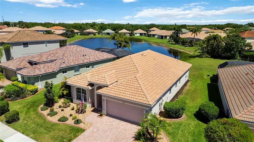 8769 Monterey Bay Loop Bradenton, FL 34212 - Photo 2 of 64 an aerial view of a house with a garden and lake view