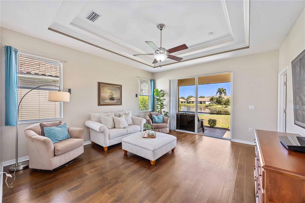 8769 Monterey Bay Loop Bradenton, FL 34212 - Photo 22 of 64 a living room with furniture or chandelier and a wooden floor