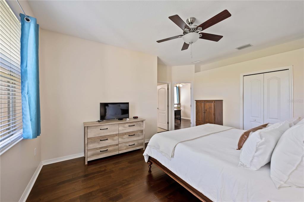8769 Monterey Bay Loop Bradenton, FL 34212 - Photo 26 of 64 a bedroom with a bed and a flat screen tv