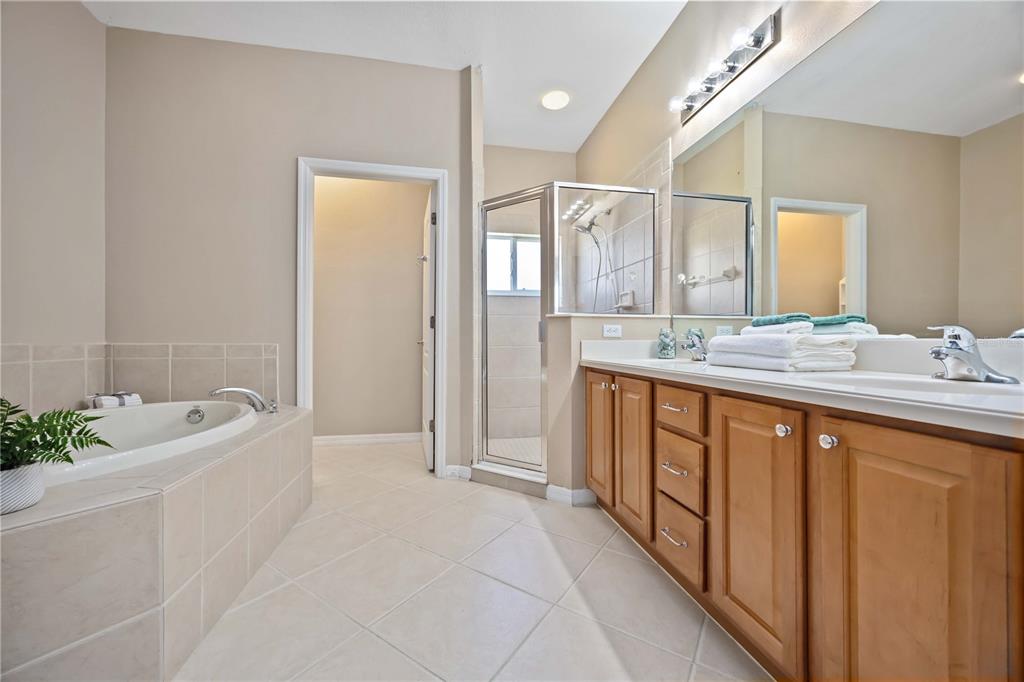 8769 Monterey Bay Loop Bradenton, FL 34212 - Photo 27 of 64 a spacious bathroom with a tub sink and mirror