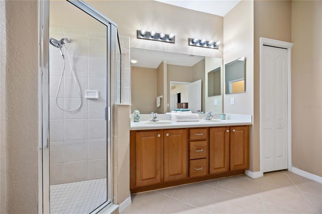 8769 Monterey Bay Loop Bradenton, FL 34212 - Photo 28 of 64 a bathroom with a double vanity sink mirror and shower