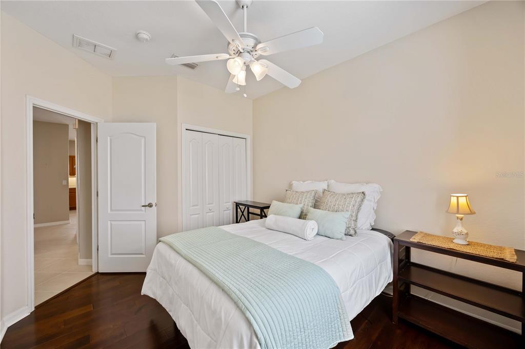 8769 Monterey Bay Loop Bradenton, FL 34212 - Photo 31 of 64 a bedroom with a bed and a chandelier