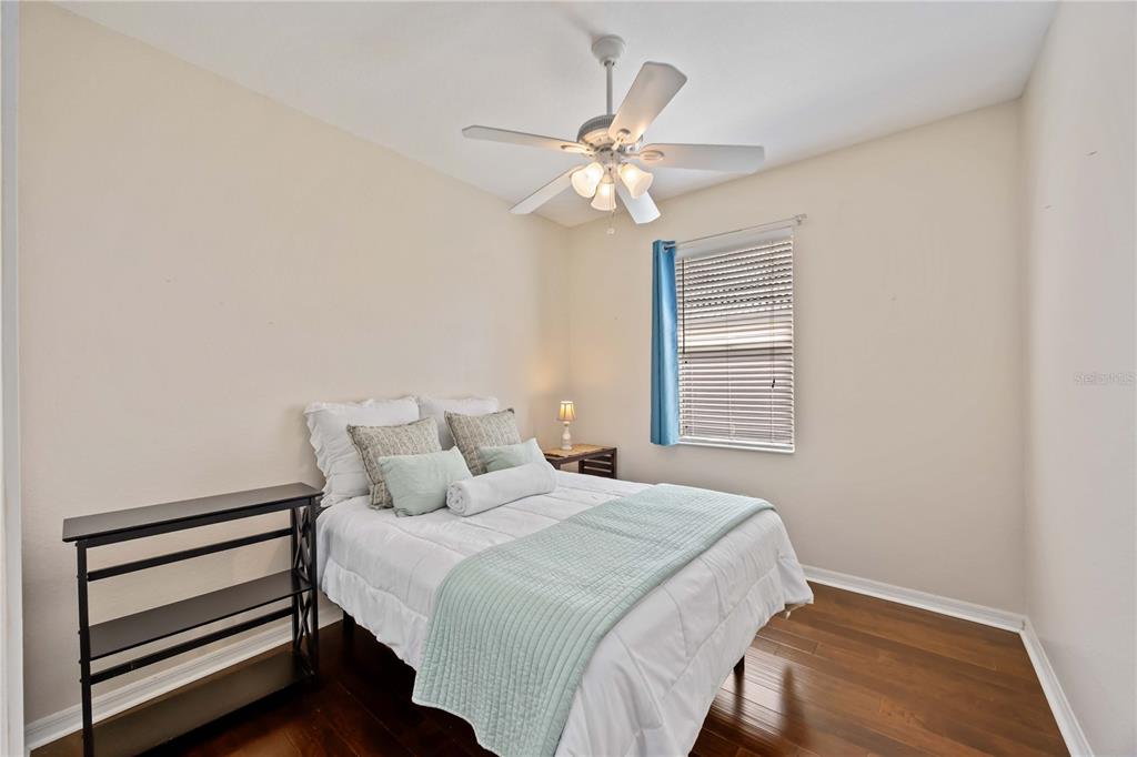 8769 Monterey Bay Loop Bradenton, FL 34212 - Photo 32 of 64 a bedroom with a bed and a chandelier