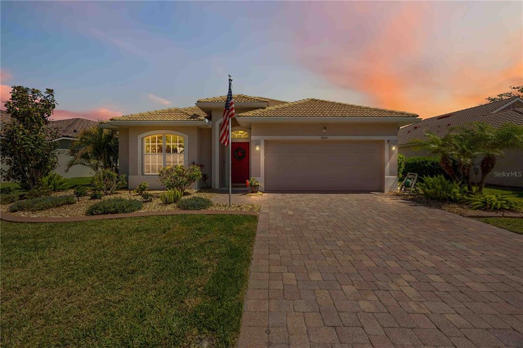 8769 Monterey Bay Loop Bradenton, FL 34212 - Photo 43 of 64 a front view of a house with garden