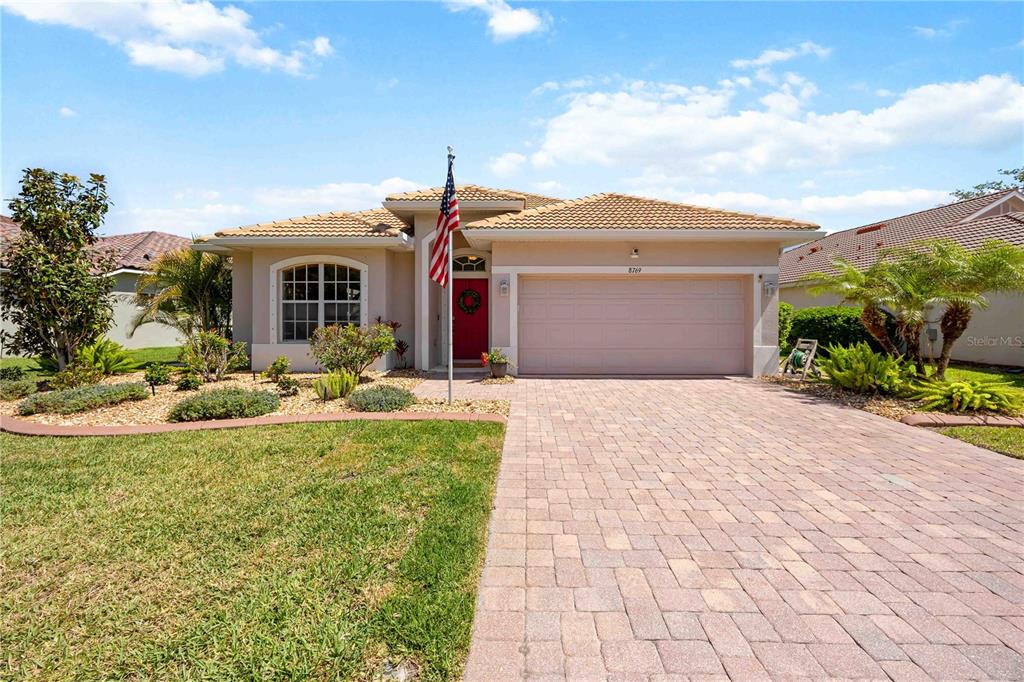 8769 Monterey Bay Loop Bradenton, FL 34212 - Photo 45 of 64 a front view of a house with garden