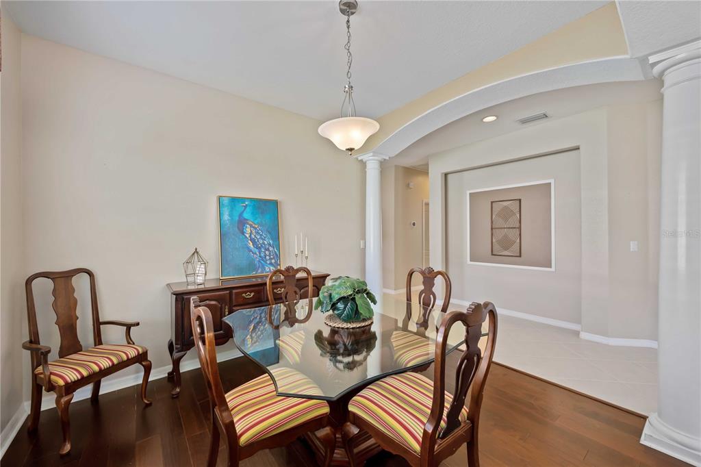 8769 Monterey Bay Loop Bradenton, FL 34212 - Photo 10 of 64 a view of a dining room with furniture and wooden floor