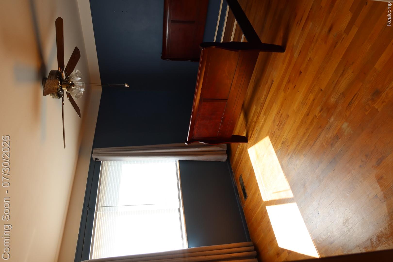 29232 Hoover Road, Unit 232 Warren, MI 48093 - Photo 9 of 22 Wood-finish flooring with a ceiling fan featuring an integrated light fixture
