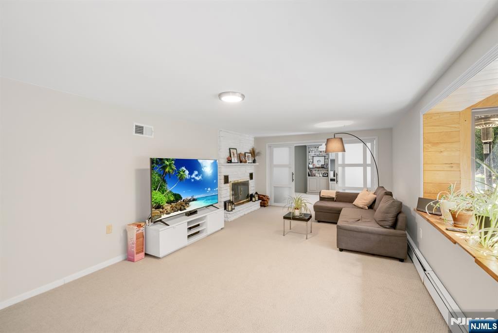 433 Piermont Road Cresskill, NJ 07626 - Photo 33 of 49 a living room with furniture and a flat screen tv