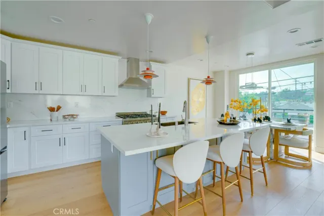 a kitchen with a sink cabinets and wooden floor
