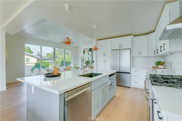 a kitchen that has a sink and a stove in it