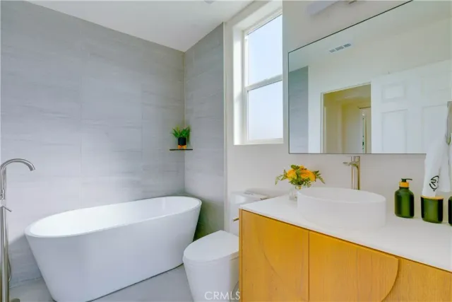 a bathroom with a sink a bathtub and a window