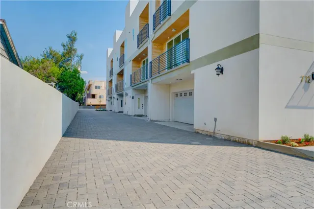 a view of a street with potted plants