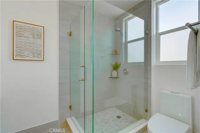 a bathroom with a shower and toilet