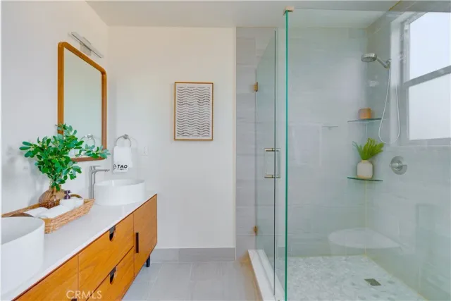 a bathroom with a granite countertop sink a toilet and shower